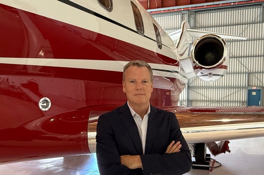 Mike Bremner in front of a private jet